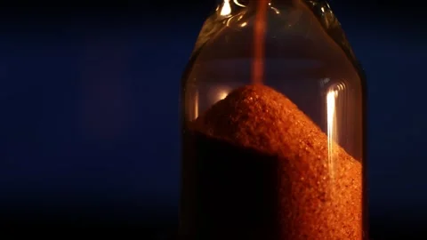Pouring brown sugar into a bottle captured in four frames with close-up shots Stock Footage 327925409