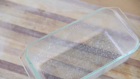 Pouring cake batter into baking pan Stock Footage 75420773