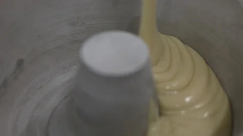 Pouring Cake Dough in a Lined Bundt Pan Stock Footage 128820219