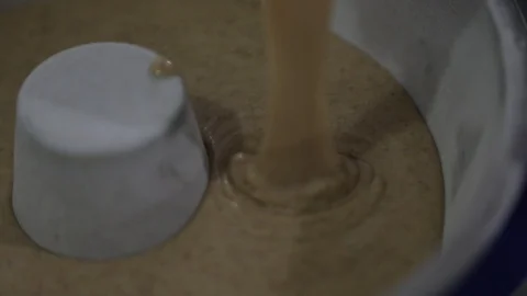 Pouring Cake Dough in a Lined Bundt Pan Stock Footage 129046041