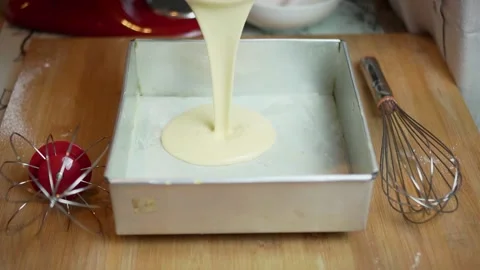 Pouring cake dough or batter into the container on the table. homemade baking Stock Footage 167811443