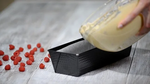 Pouring cake mix into baking tin. Stock Footage 92731351