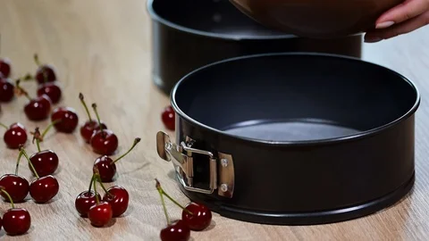 Pouring cake mix into baking tin. Stock Footage 94331635