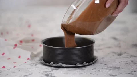 Pouring cake mix into baking tin. Making Chocolate Layer Cake. Series. Stock Footage 197333054