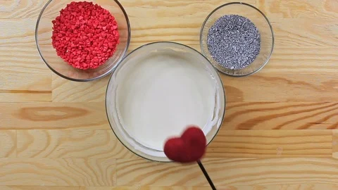 Pouring cake pop in the form of a heart white chocolate, top view Stock Footage 126213032