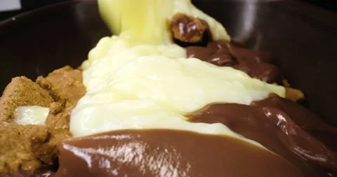 Pouring castard on biscuits, macro shot, desert Stock Footage 146514629