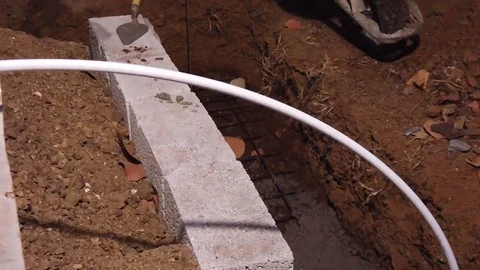 Pouring cement into the ditch to build the foundation of a house, porch, Video stock 106565198