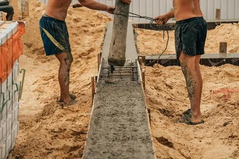 Pouring cement or concrete with automatic pump, construction site with Stock Photos