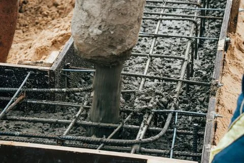 Pouring cement or concrete with automatic pump, construction site with Stock Photos