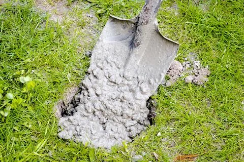 Pouring in cement solution with rubble, slurry, concrete mortar in pit or hol Stock Photos