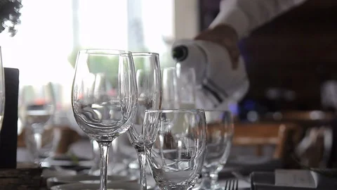 Pouring champagne into 2 drinking glasses slider close up Stock Footage 92548643