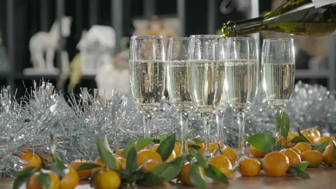 Pouring champagne, table decorated with garlands and tangerines Stock Footage 225546288