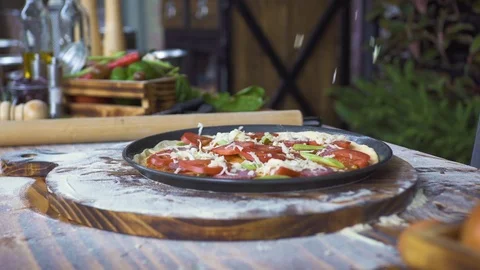 Pouring cheese on raw pizza while preparation on pizzeria kitchen. Pizzaillo Stock Footage 99033065