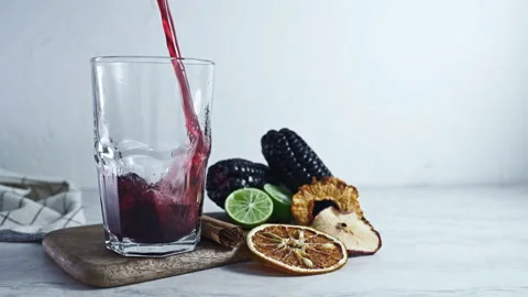 Pouring Chicha Morada, Purple Corn Drink with Lime and Cinnamon Stock Footage 335893726