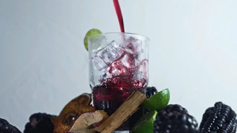 Pouring Chicha Morada, Purple Corn Drink with Lime and Cinnamon Stock Footage 335893732