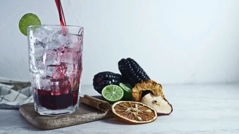 Pouring Chicha Morada, Purple Corn Drink with Lime and Cinnamon Vídeo Stock 344175542