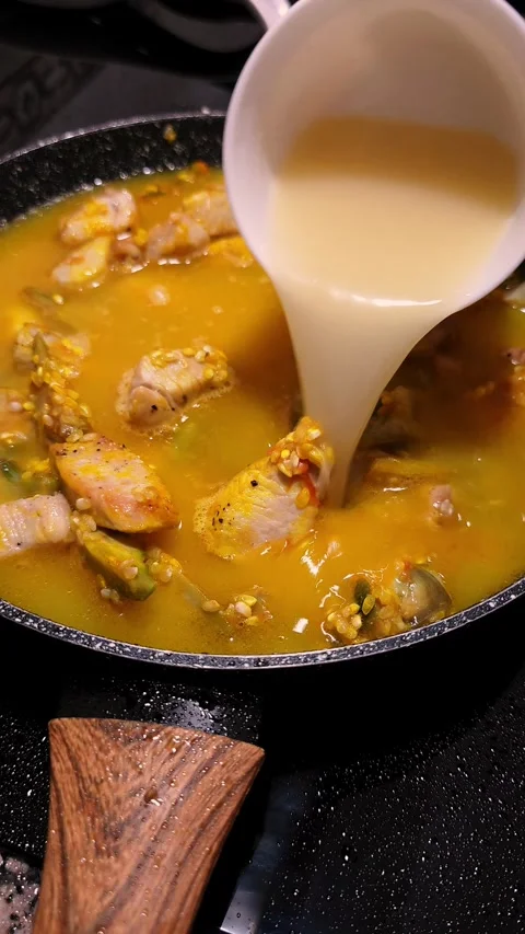Pouring Chicken Broth Over Rice for Paella Cooking. Stock Footage 344967649
