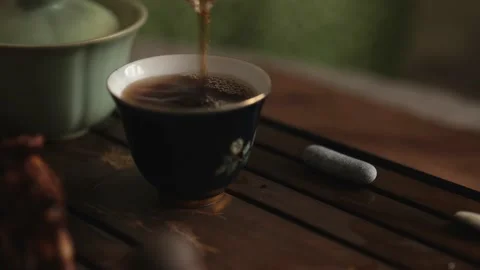 Pouring chinese tea into a handmade ceramic bowl. sounds of pouring water Stock Footage 220537022