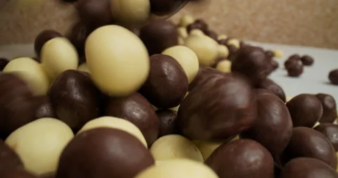 Pouring chocolate balls in close up, macro shot, desert Stock Footage 146515160