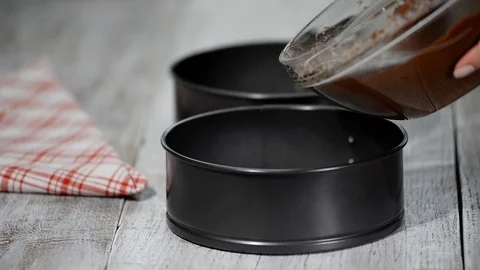 Pouring chocolate batter into pan. Stock Footage 101593187