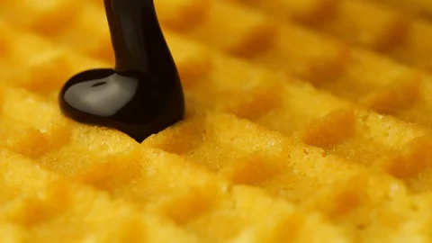 Pouring chocolate on a crispy waffle in slow motion, close-up Stock Footage 114307904