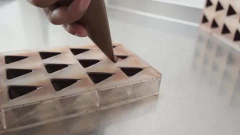 Pouring chocolate into a mold. Stock Footage 132787377