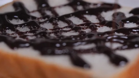 Pouring the chocolate over the bread slices Stock Footage 128181031