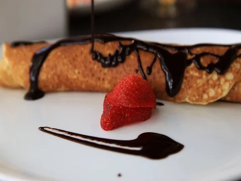 Pouring chocolate over pancakes Stock Footage