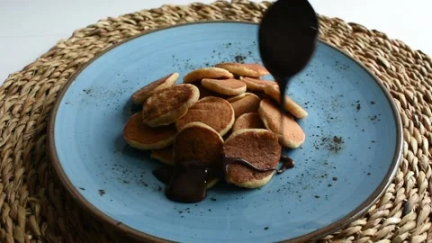 Pouring chocolate on pancakes Stock Footage 140170024