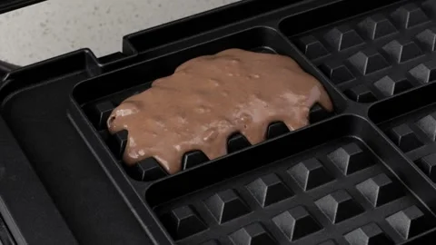 Pouring chocolate waffle batter into waffle maker Stock Footage 161345708