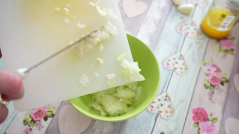 Pouring chopped onion in the bowl Stock Footage 232945341