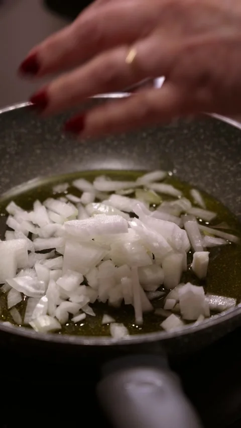 Pouring chopped onion into pan. Video stock 346620228