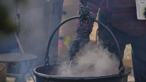Pouring cider into cup from steaming cauldron outside fall 動画素材 121074612