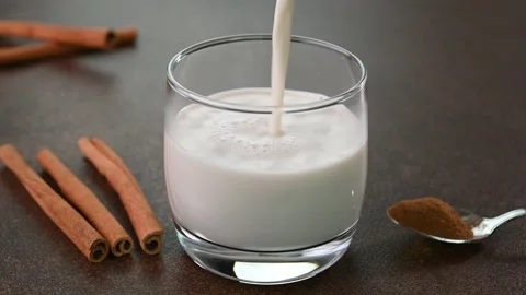 Pouring cinnamon milk Stock Footage 245698870