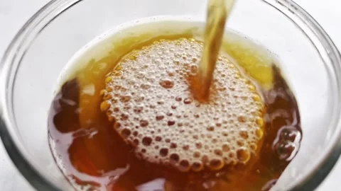 Pouring citrus tea in cup close-up Stock Footage 338343304