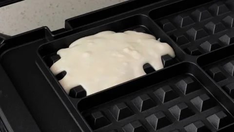 Pouring classic vanilla waffle batter into waffle maker Stock Footage 161345697