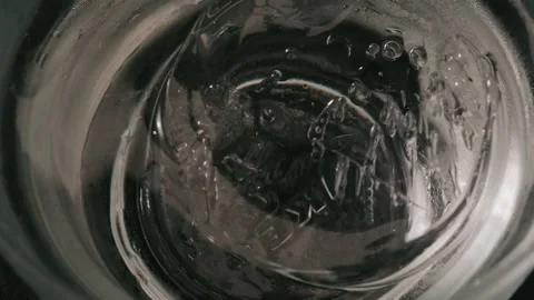 Pouring clear liquid over ice close up Stock Footage 339843239