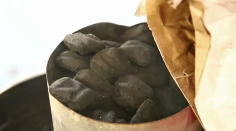 Pouring Coals Into a Cylindrical Grill Stock-Footage 37715398
