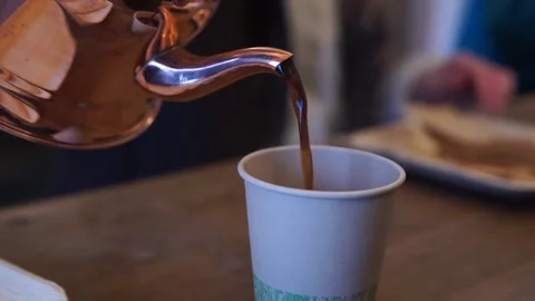 Pouring coffe at the lunchtable Stock Footage 233900530