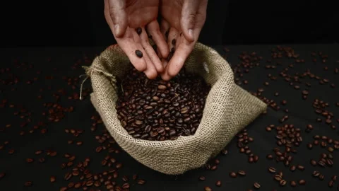 Pouring coffee beans into the bag Stock Footage 208761154