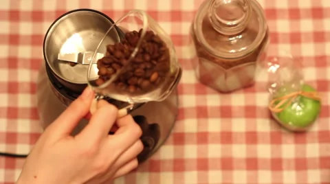 Pouring coffee beans into a coffee grinder Stock Footage 59887327
