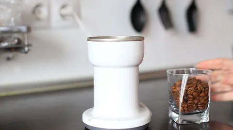 Pouring coffee beans to a coffee grinder Stock Footage 61940135