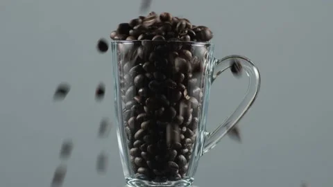 Pouring coffee beans into a cup Stock Footage 138213242
