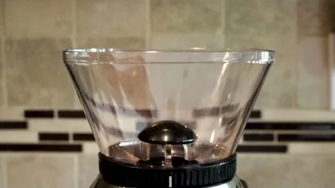 Pouring Coffee Beans into a Grinder - slow motion Stock Footage 131475840