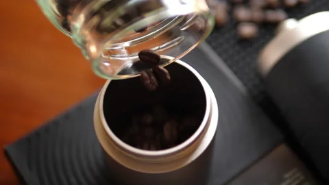 Pouring Coffee Beans in a jar Stock Footage 238982458