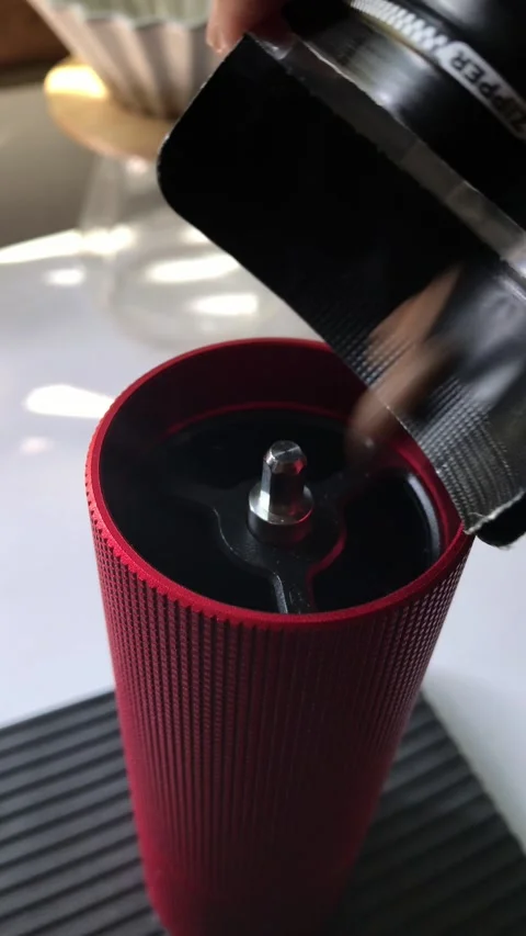 Pouring Coffee Beans into Manual Grinder Stock Footage 277314277