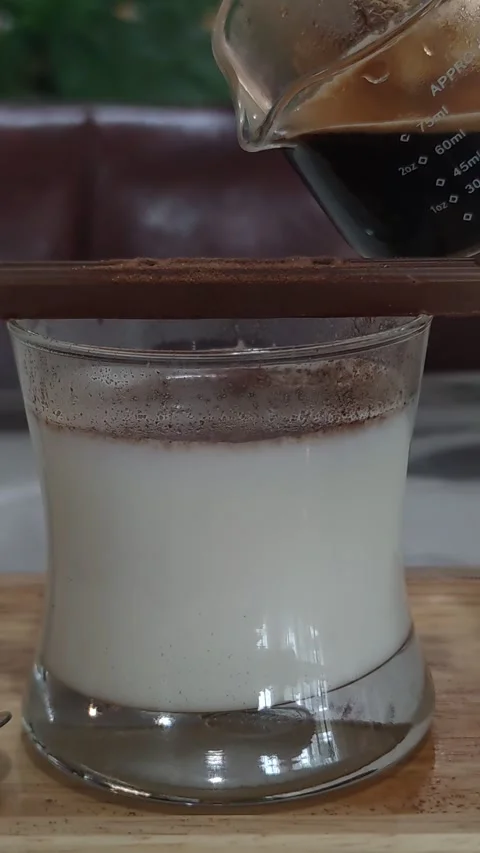 Pouring coffee on a chocolate bar, close up shot, vertical video Stock Footage 245699028