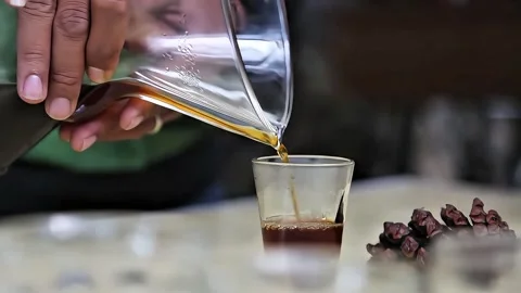 Pouring coffee from a clear pot into a clear glass Stock Footage 293167681