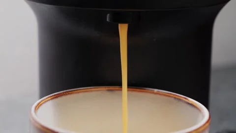 Pouring coffee from coffee machine into cup in coffee shop, close up of Stock Footage 317763579