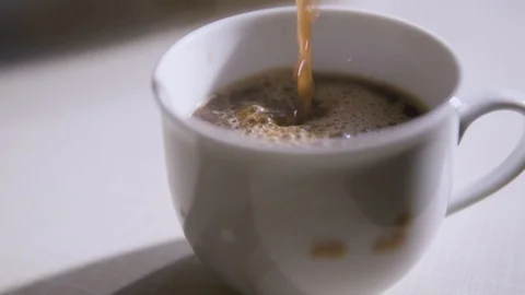 Pouring  coffee into a cup Stockbeeldmateriaal 88910007